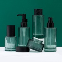 Green Cylinder Thick Bottom Skincare Glass Packaging Set. Cosmetic Products Bottles